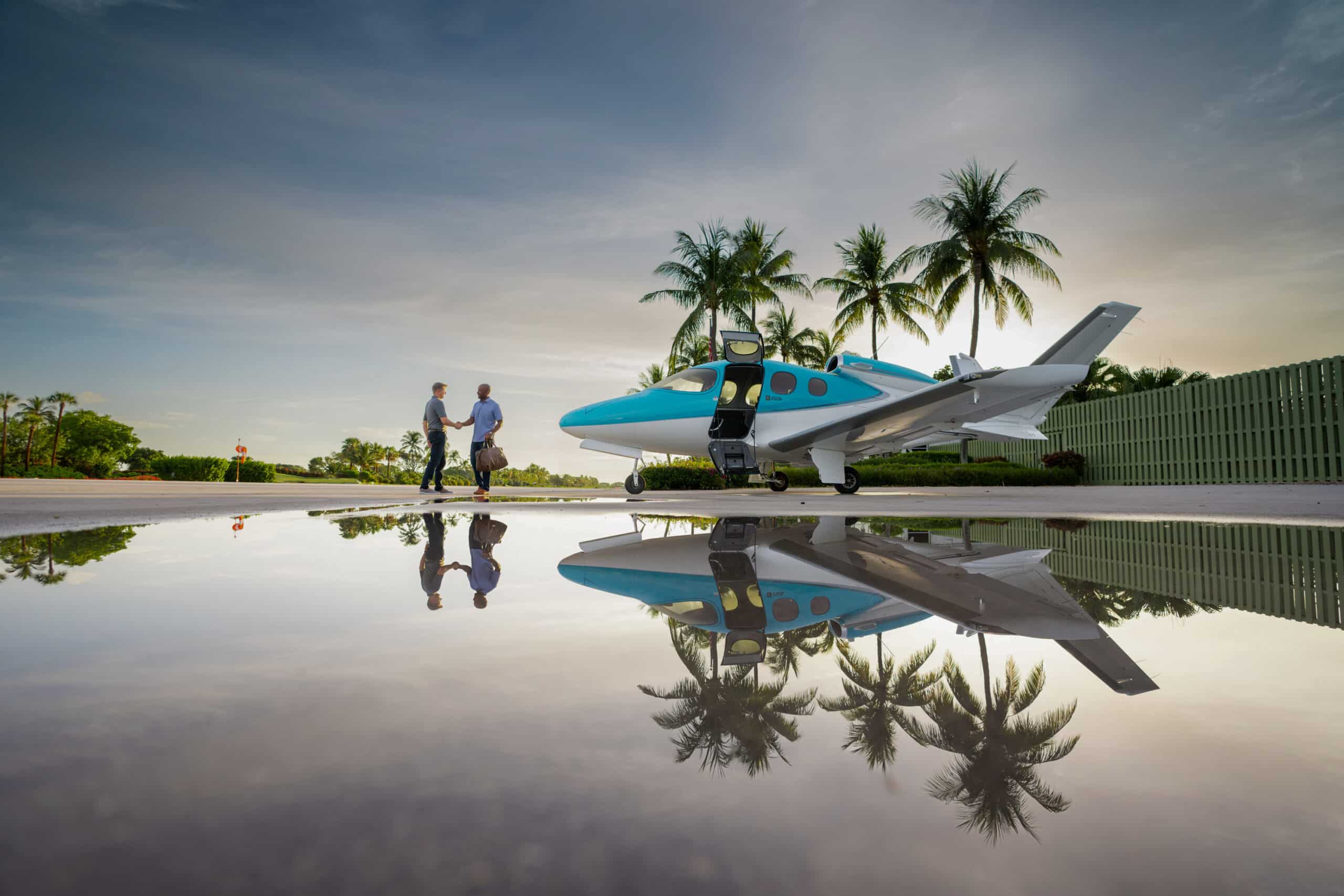 people shaking hands in front of cirrus jet